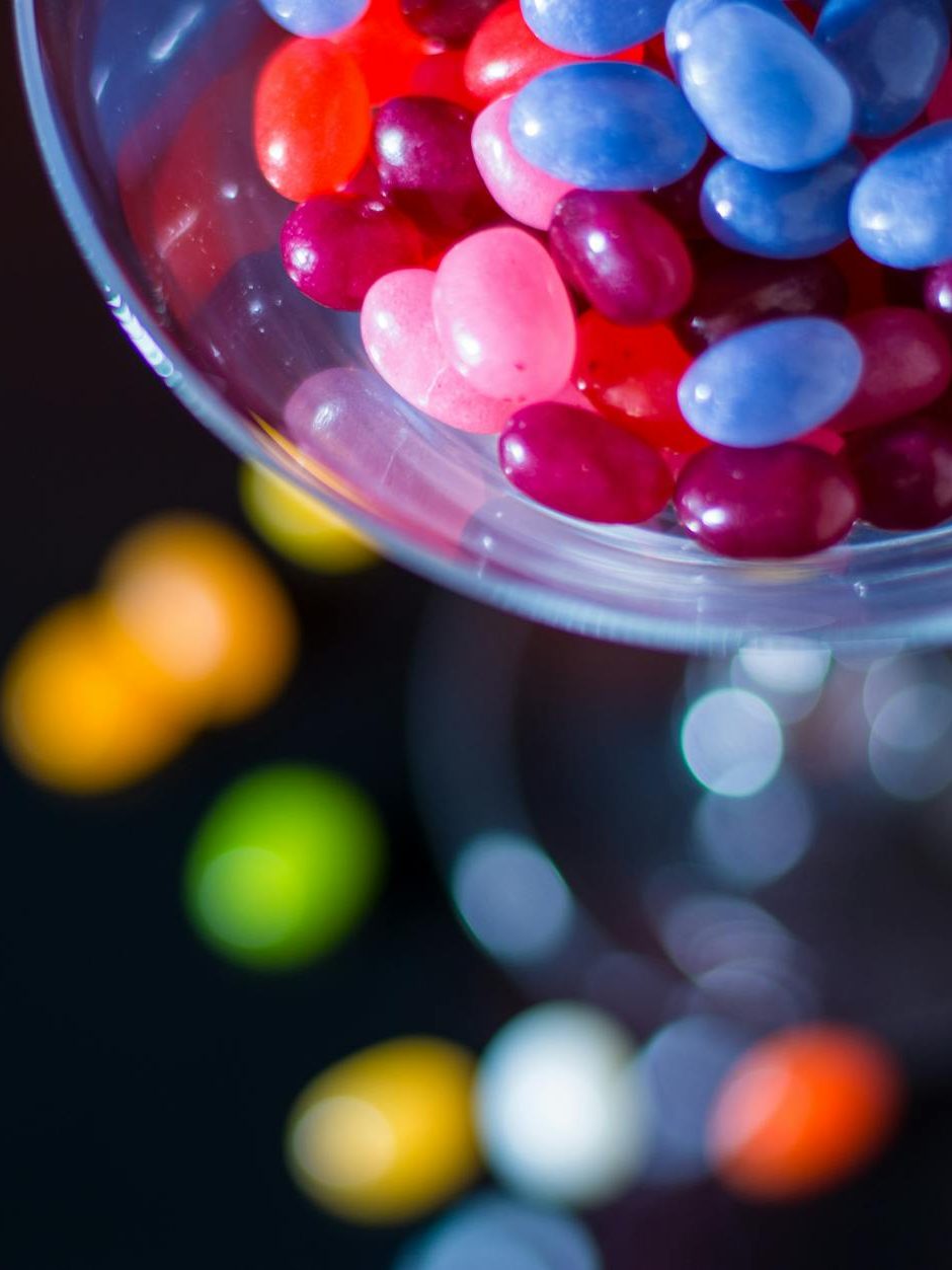 selective focus photography of jelly beans on jar